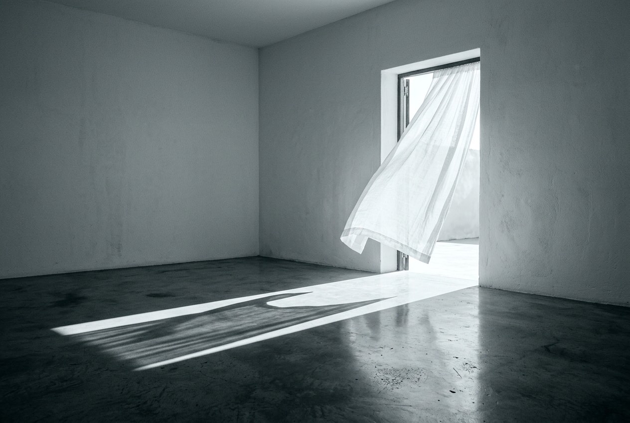Lumière traversant une porte ouverte dans une pièce vide